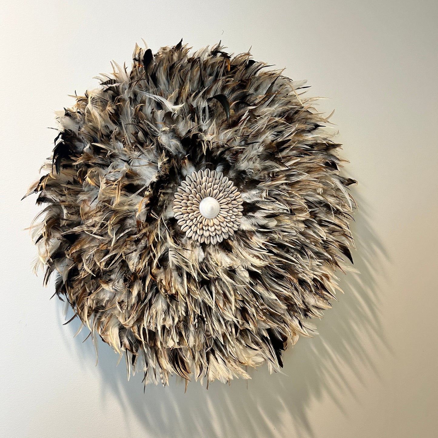 Feathered juju hat centred above bed