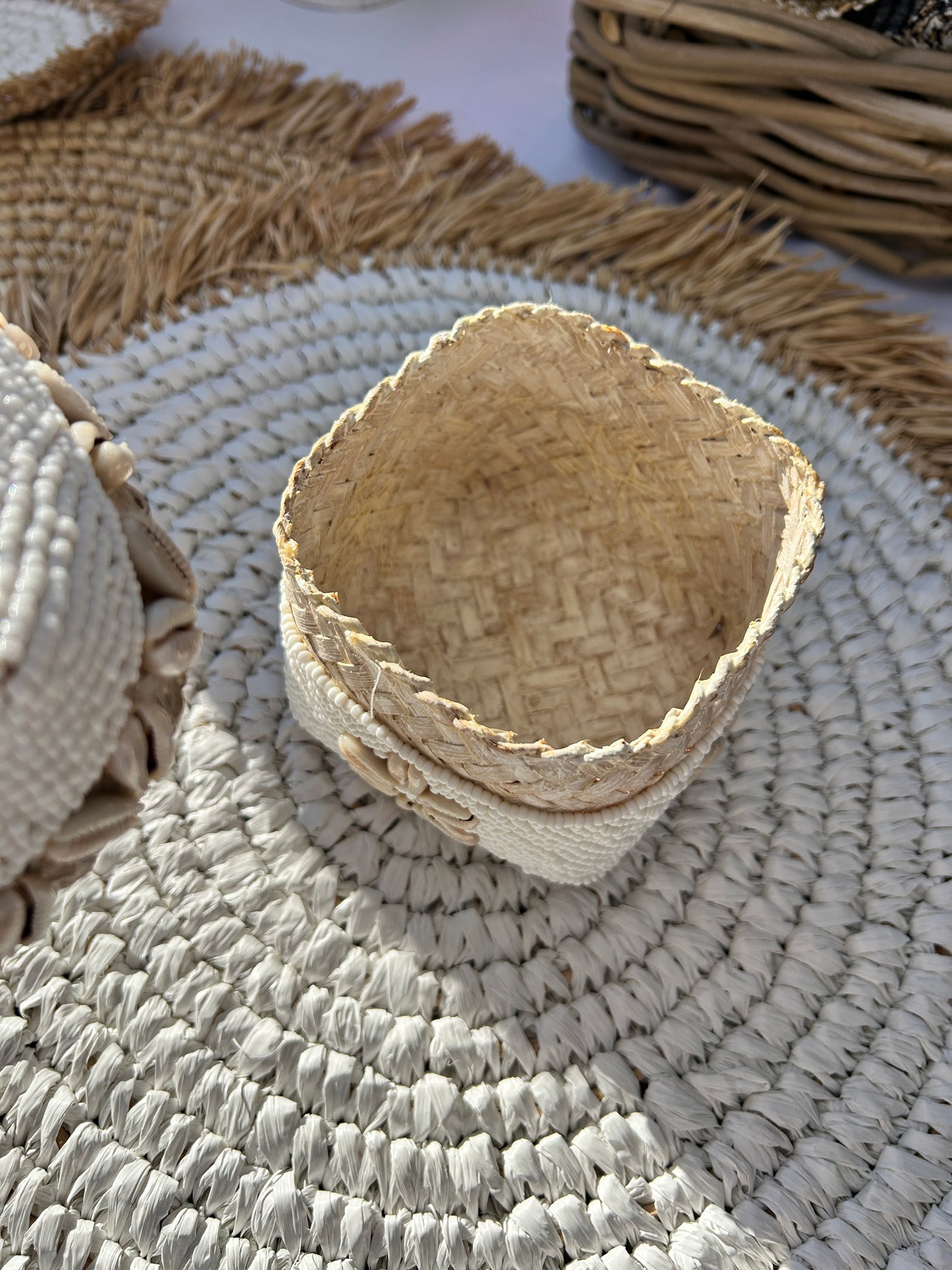 Inside of white hand beaded trinket box with natural coloured cowrie shell design