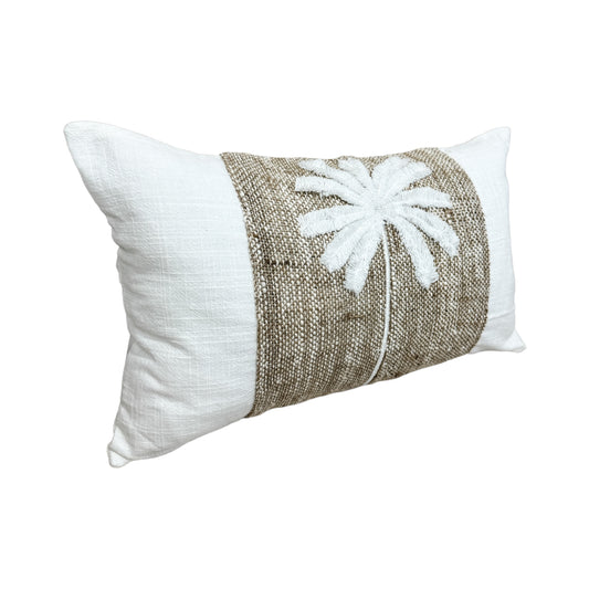 A rectangular decorative lumbar throw pillow with a white linen-textured body, a central natural jute band, and a white embroidered palm tree motif on the front, shown against a plain white background. Coastal luxe.