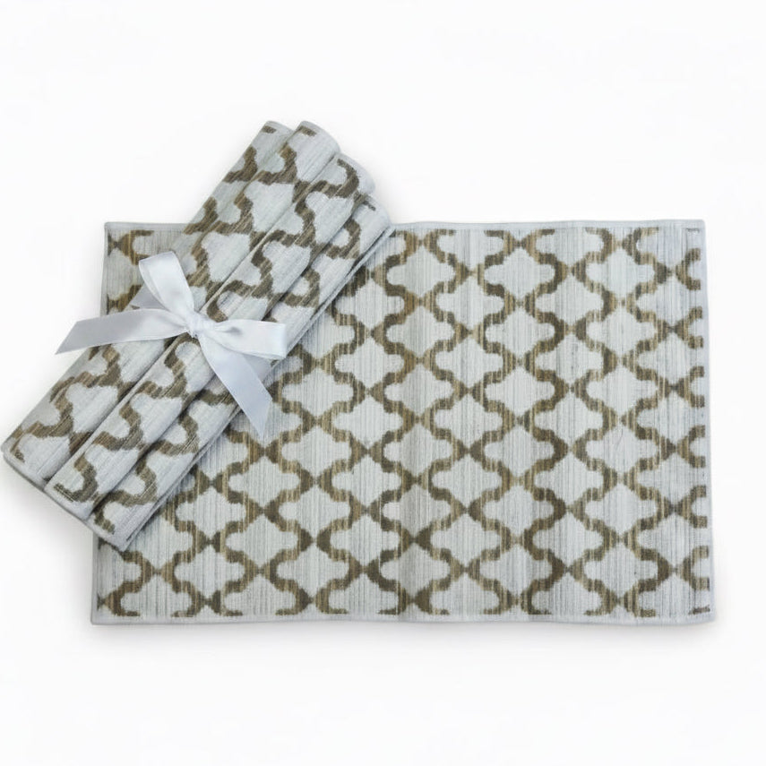 A set of textured placemats with a repeating geometricwhite pattern - set of 6 with white ribbon tied around
