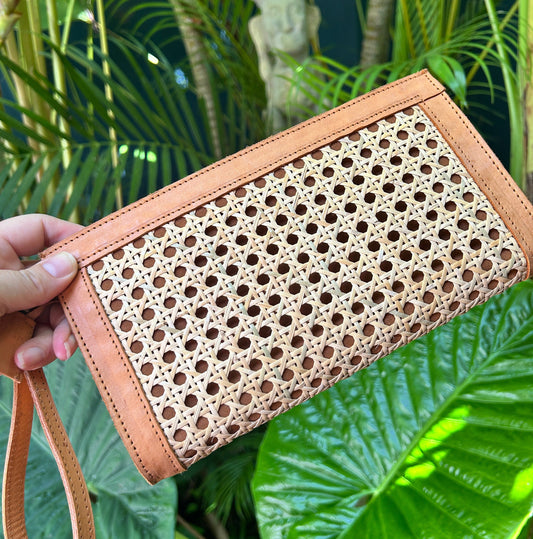 Handheld tan leather and rattan clutch bag with wrist strap and zipper