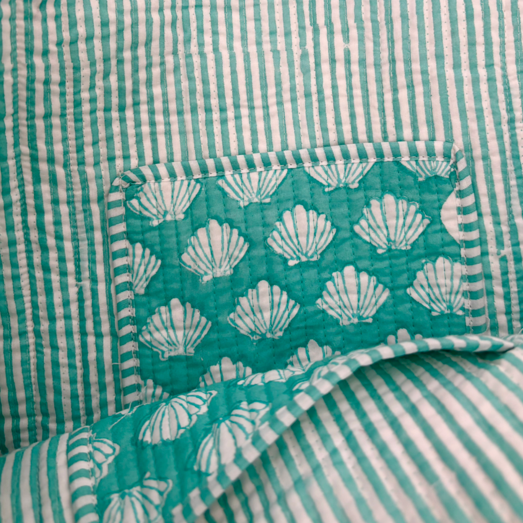 Inside lining of block printed tote bag - turquoise and white striped fabric with shell patterned pocket